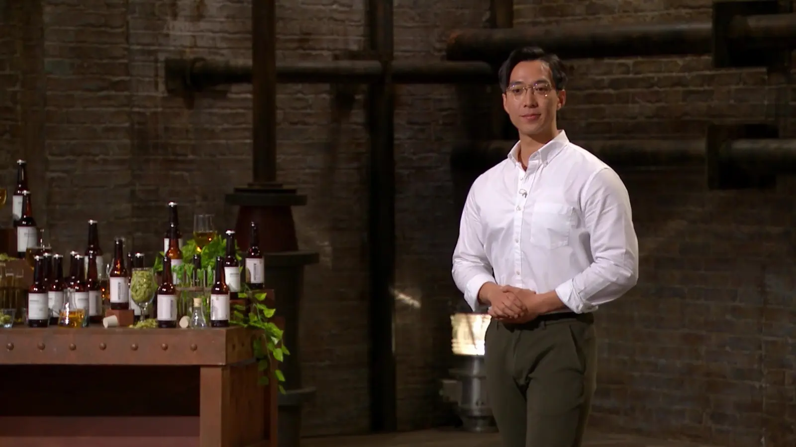 Mark Wong beside the IMPOSSIBREW product display on Dragons' Den